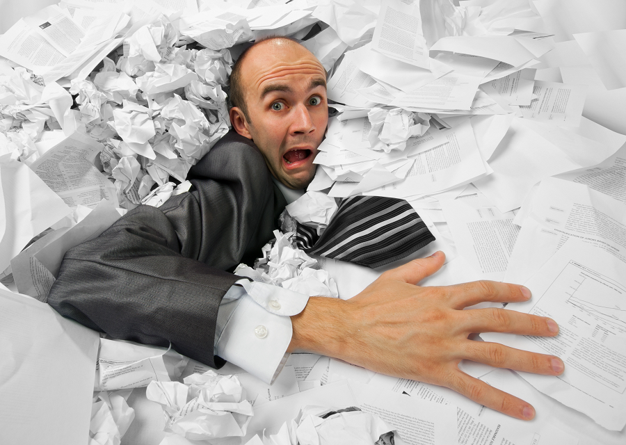adversity-man-stuck-in-pile-of-papers