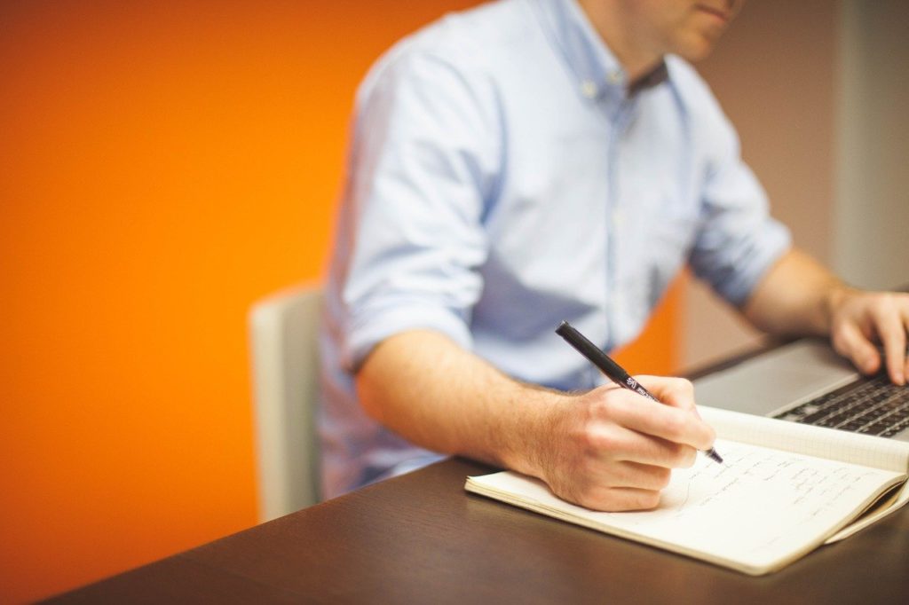 man taking notes-man writing-working-note