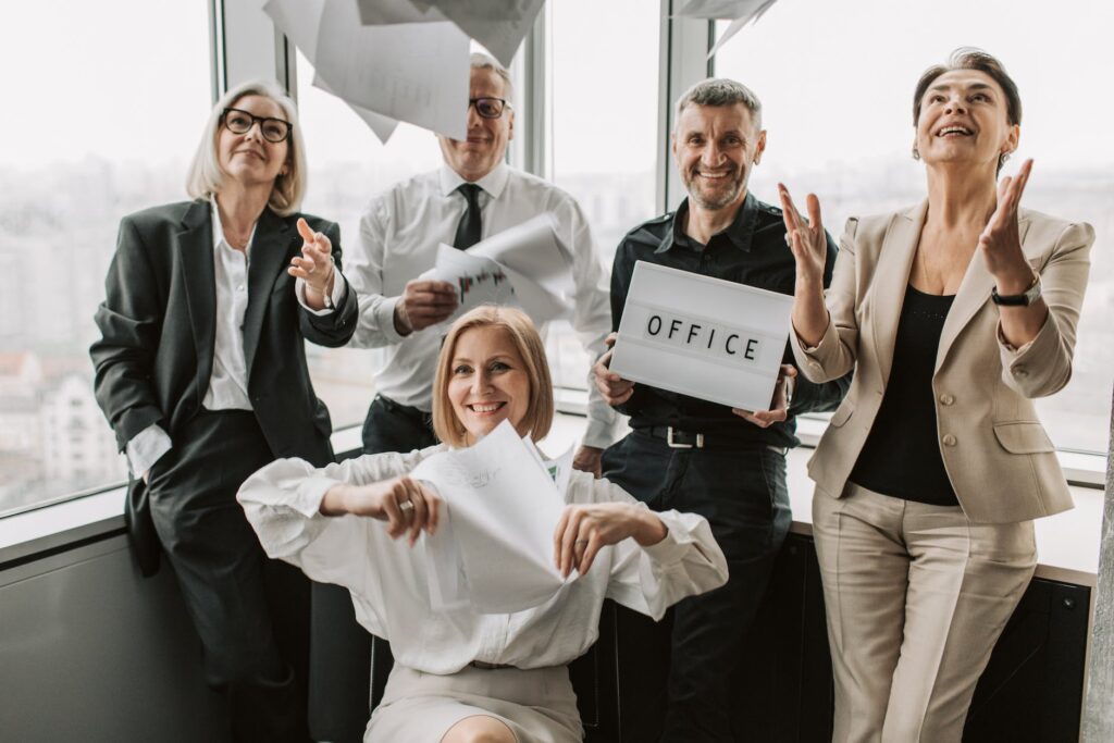 photograph of adults throwing sheets of paper