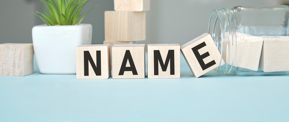 text name written on wood cubes that lie on wood cubes. High quality photo