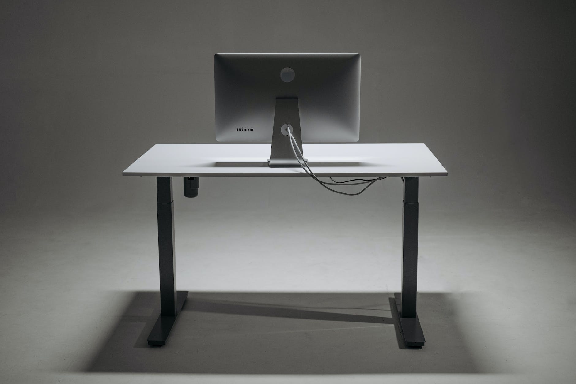 a monitor on a height adjustable desk