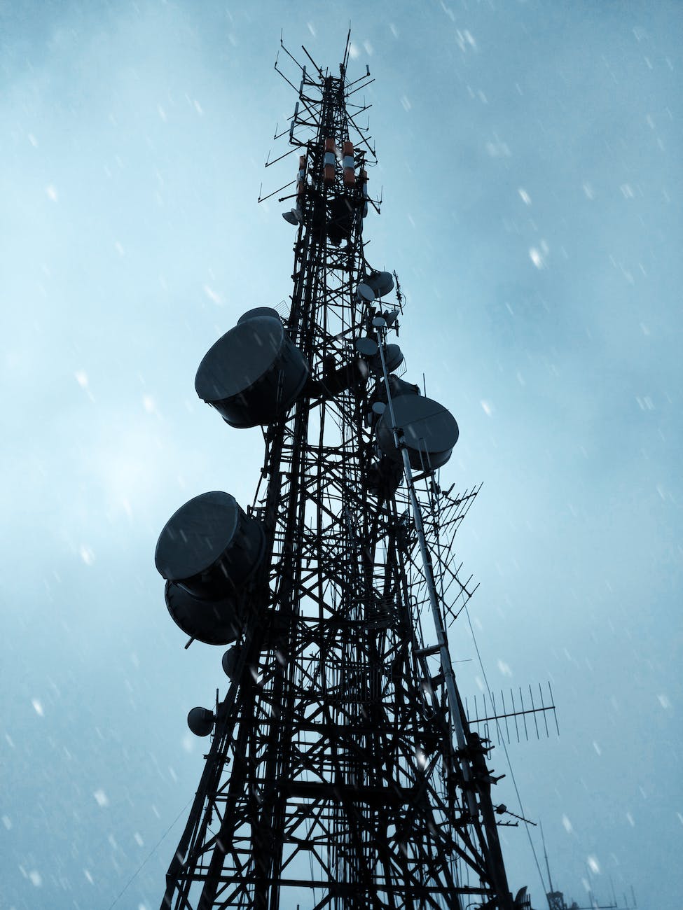 black satellite tower under blue skies