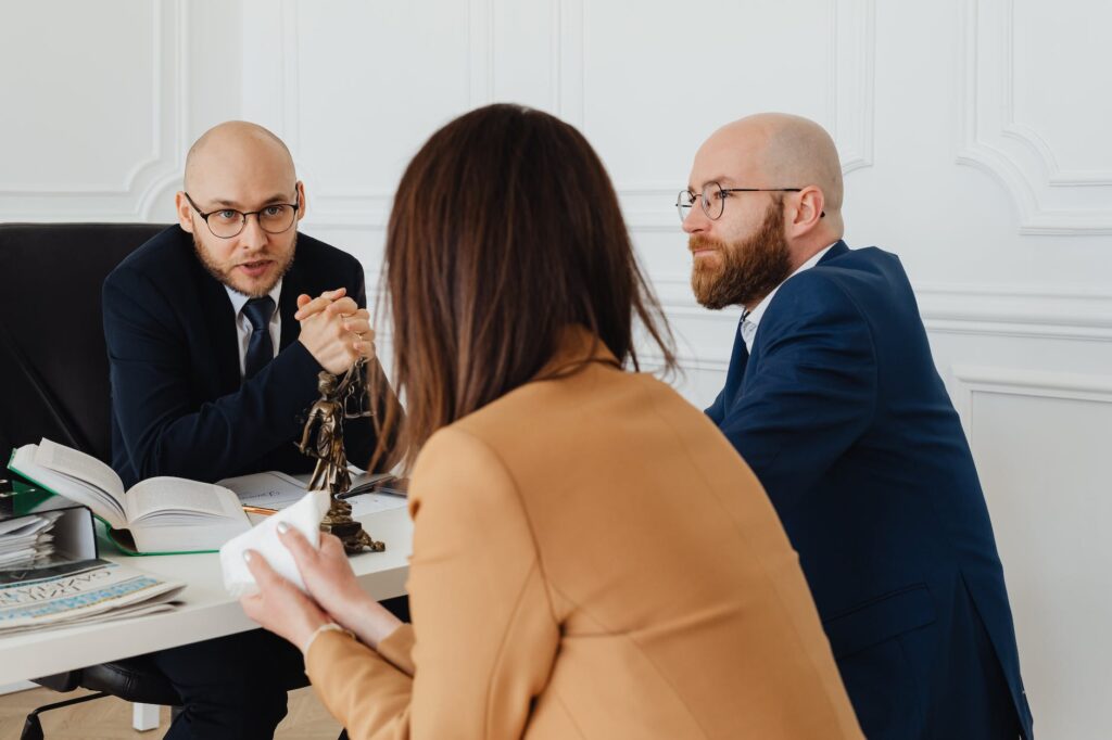 a lawyer talking to the woman wearing brown blazer