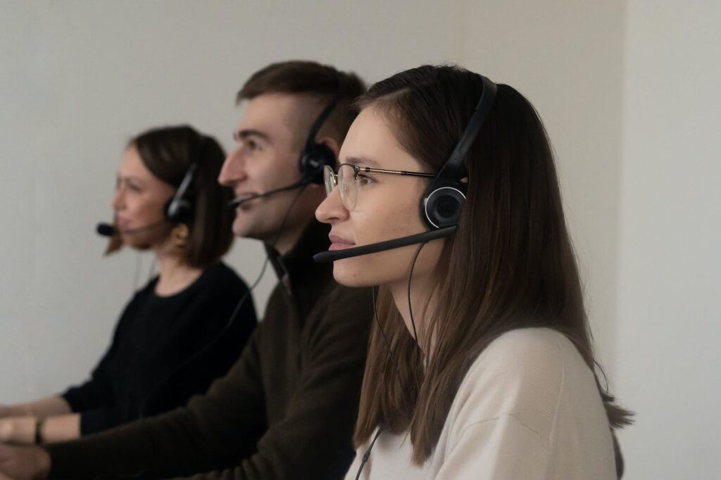 colleagues with headphones with microphone in room