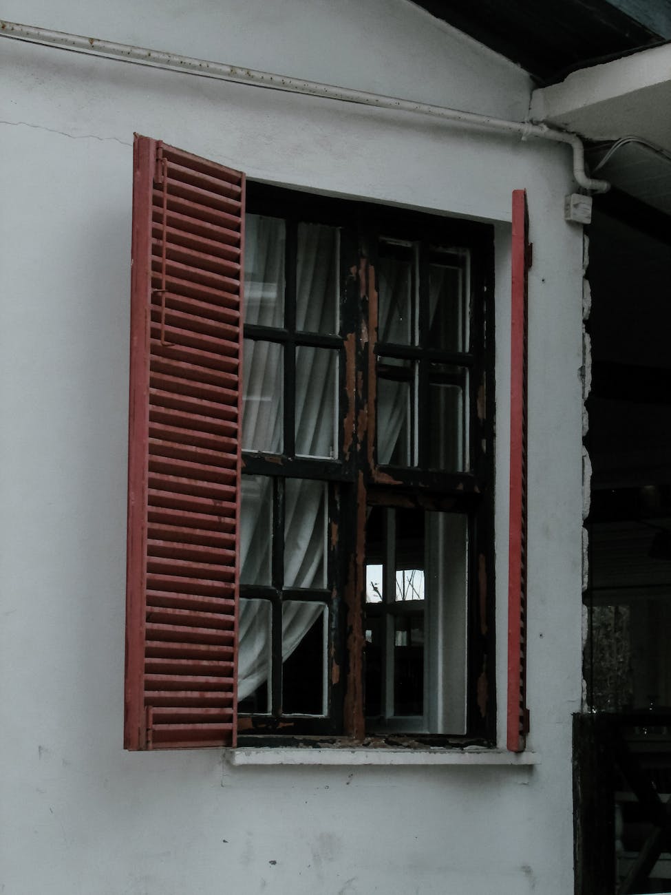 house facade and window with red shutters