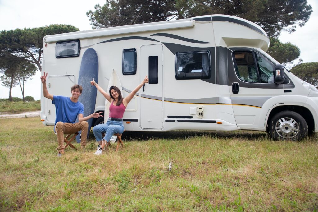 couple sitting outside the rv