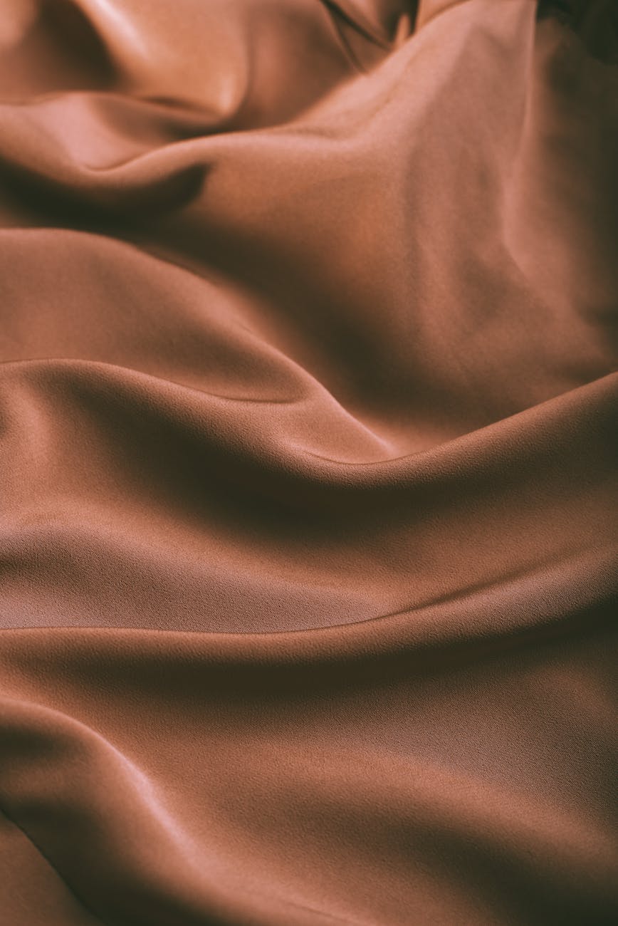 background of smooth rippled brown silk fabric