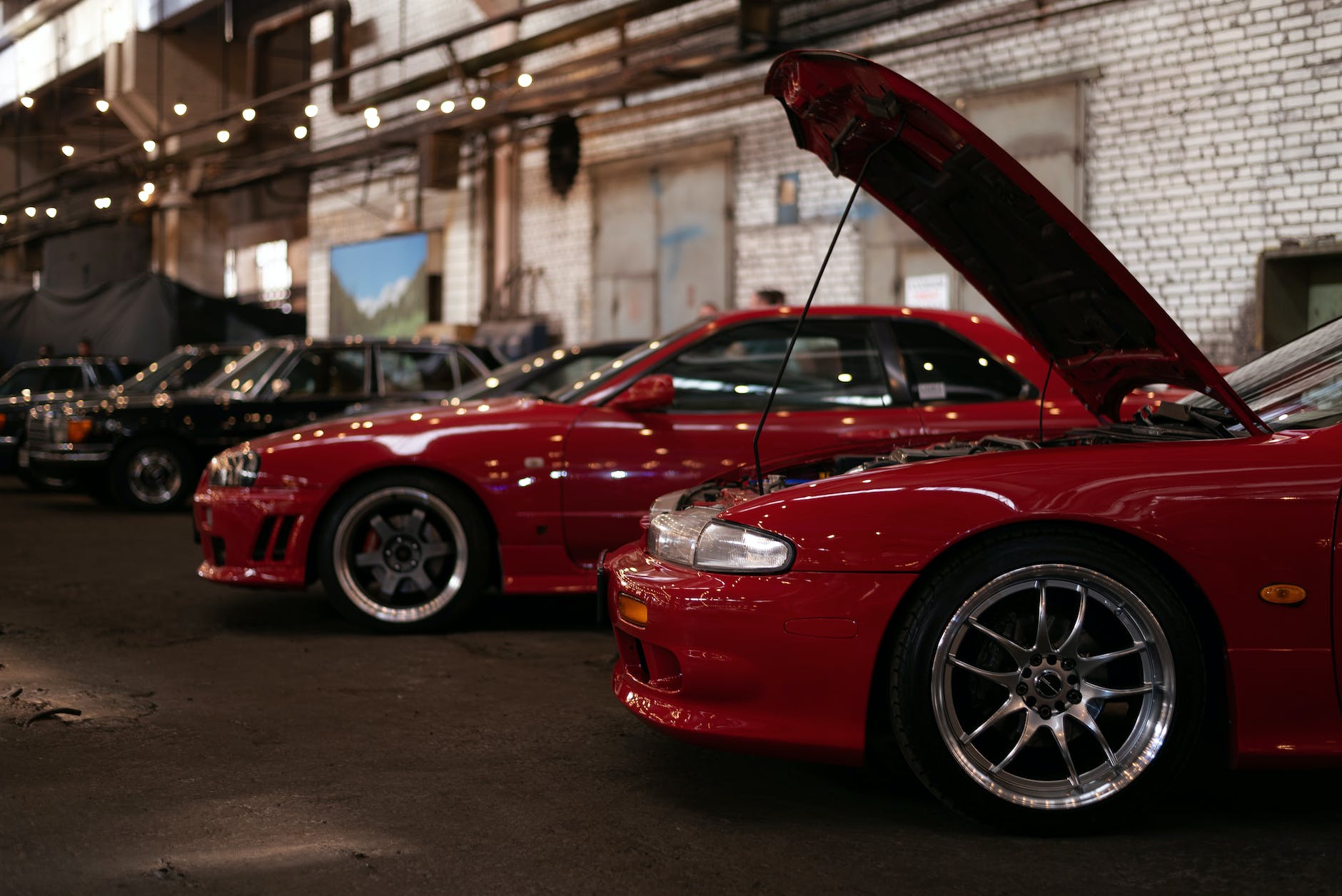drift cars on a car meet in a garage
