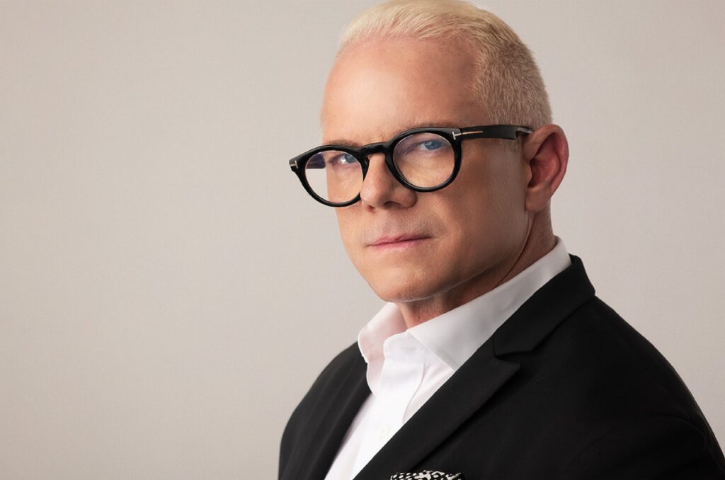 man in black suit wearing black framed eyeglasses