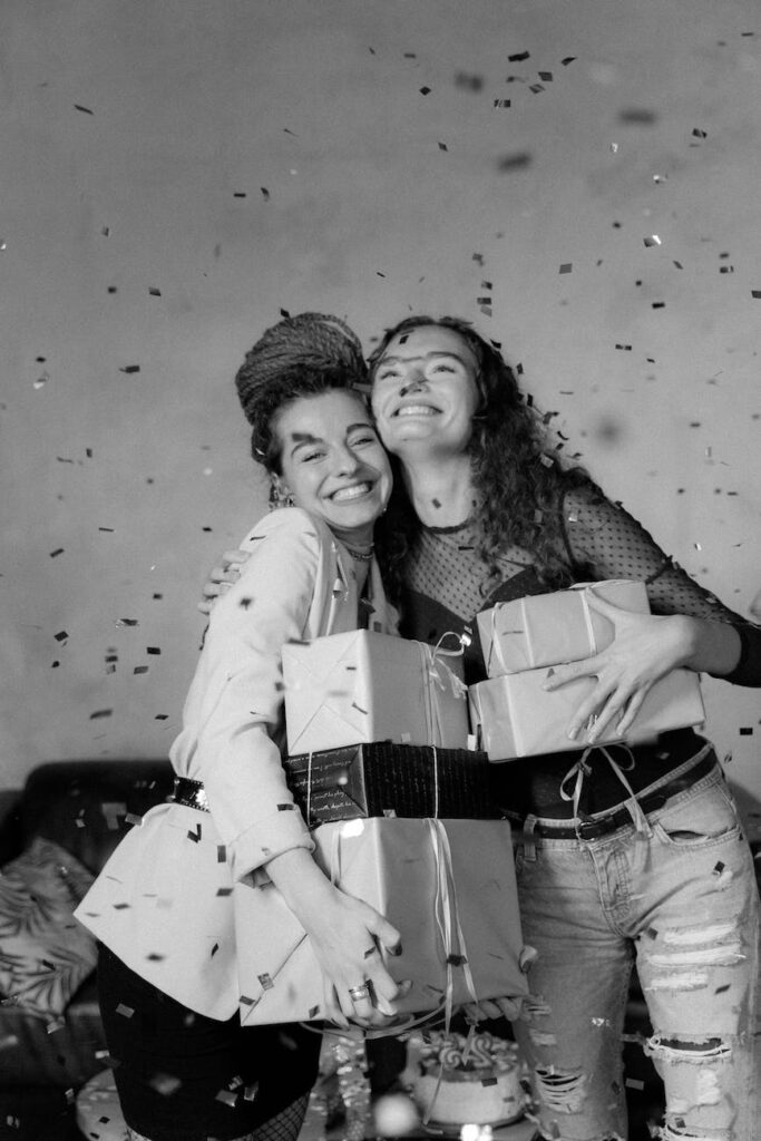 a falling confetti on women holding gifts