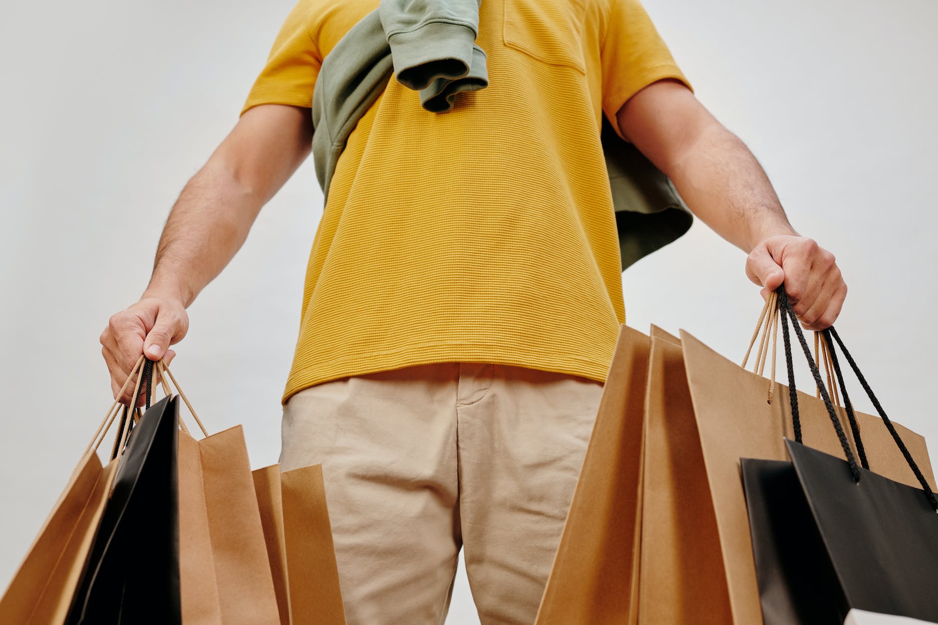 man in yellow shirt and brown pants