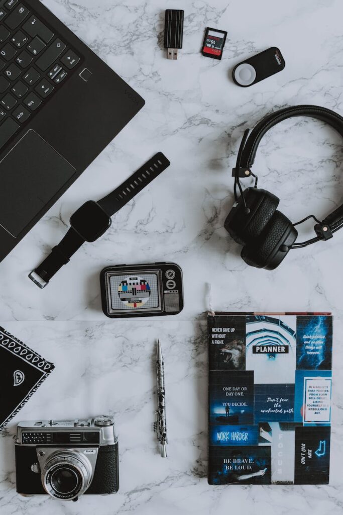 black apple watch and wireless headphones