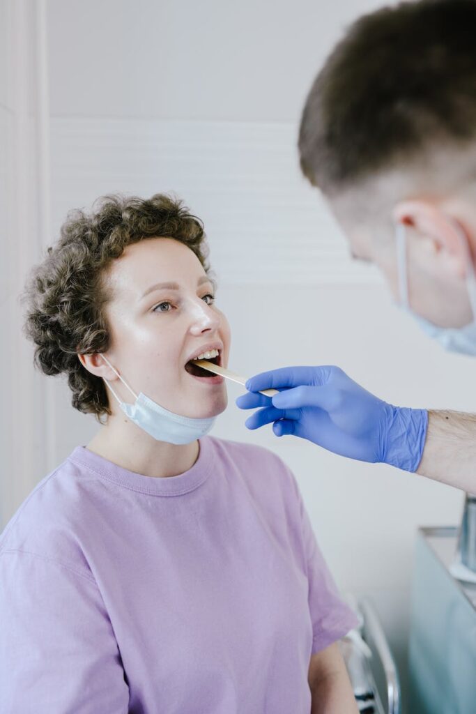 woman getting her throat swabbed for covid