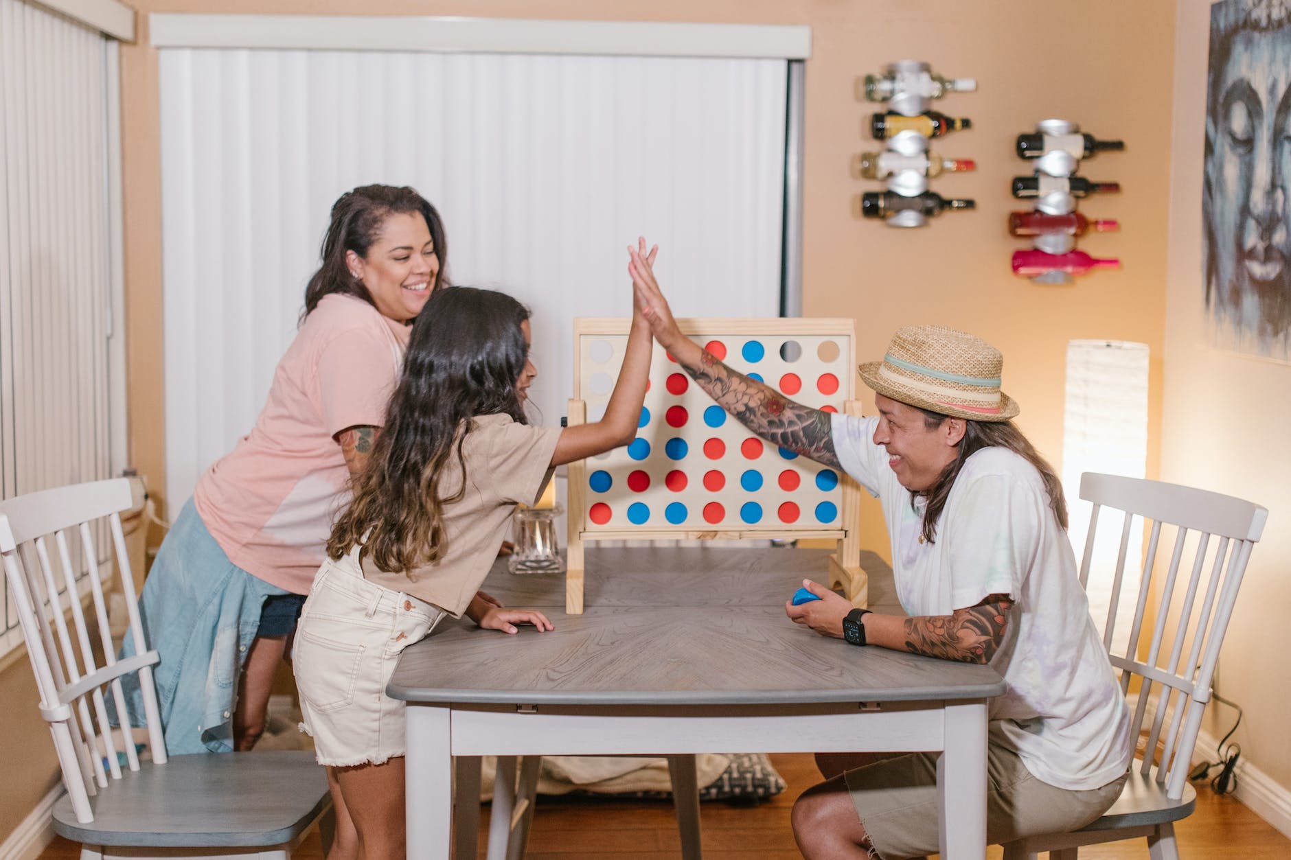 cheerful family enjoying connect four game