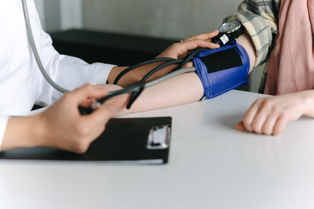 a-healthcare-worker-measuring-a-patient-s-blood-pressure-using-a-sphygmomanometer