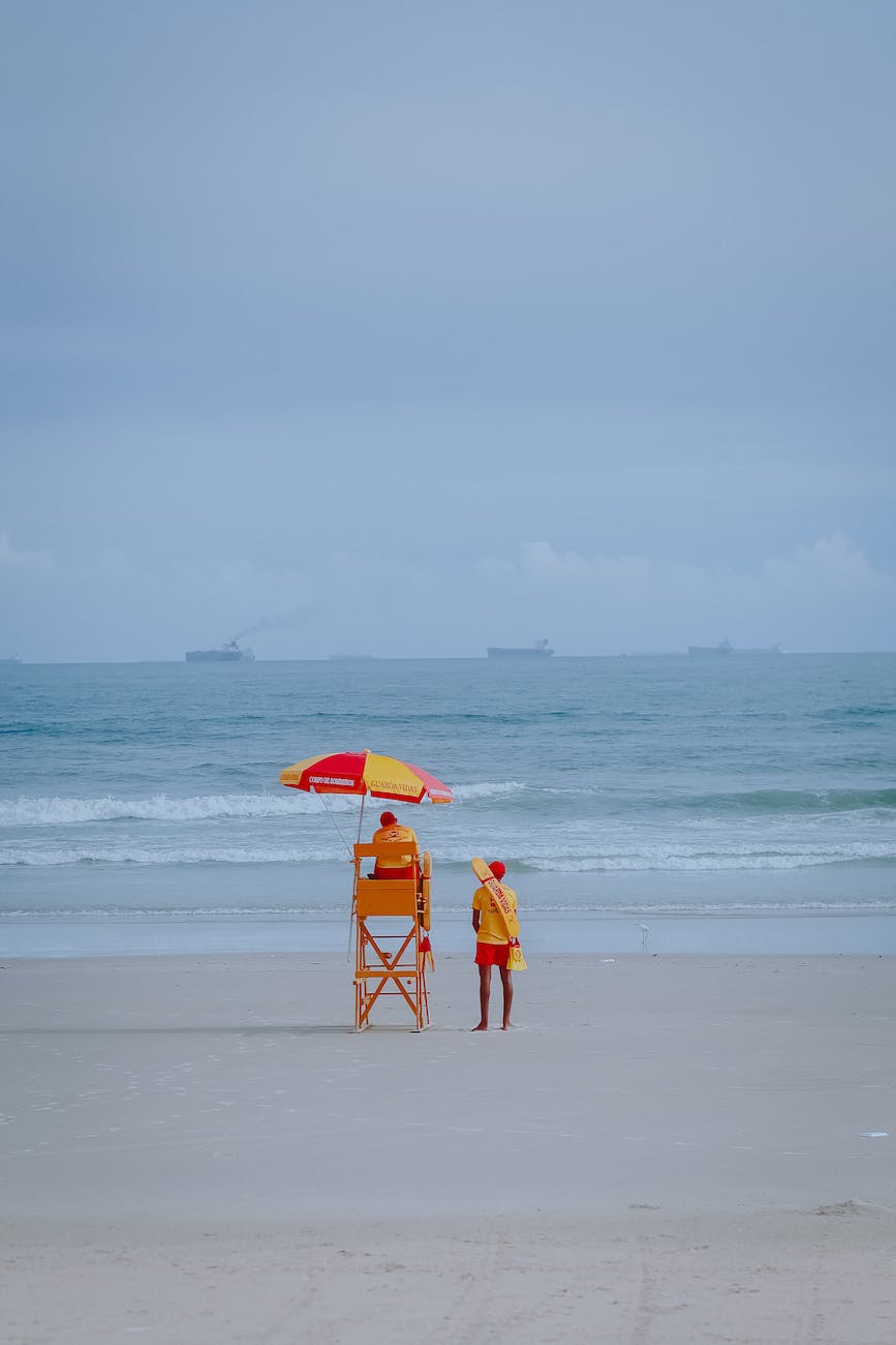 lifeguards on beach in back view