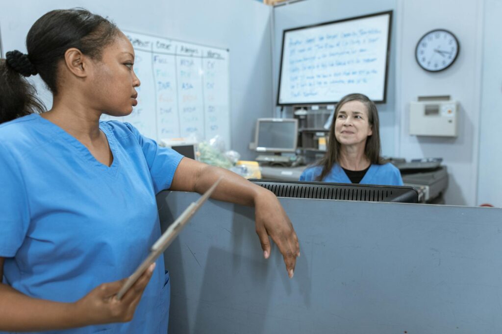 nurse in blue scrub suit holding a clipboard