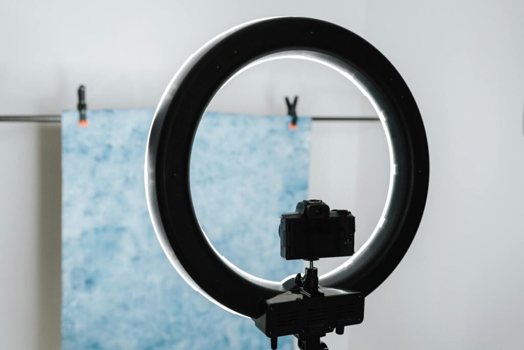 modern photo camera placed near studio lamp
