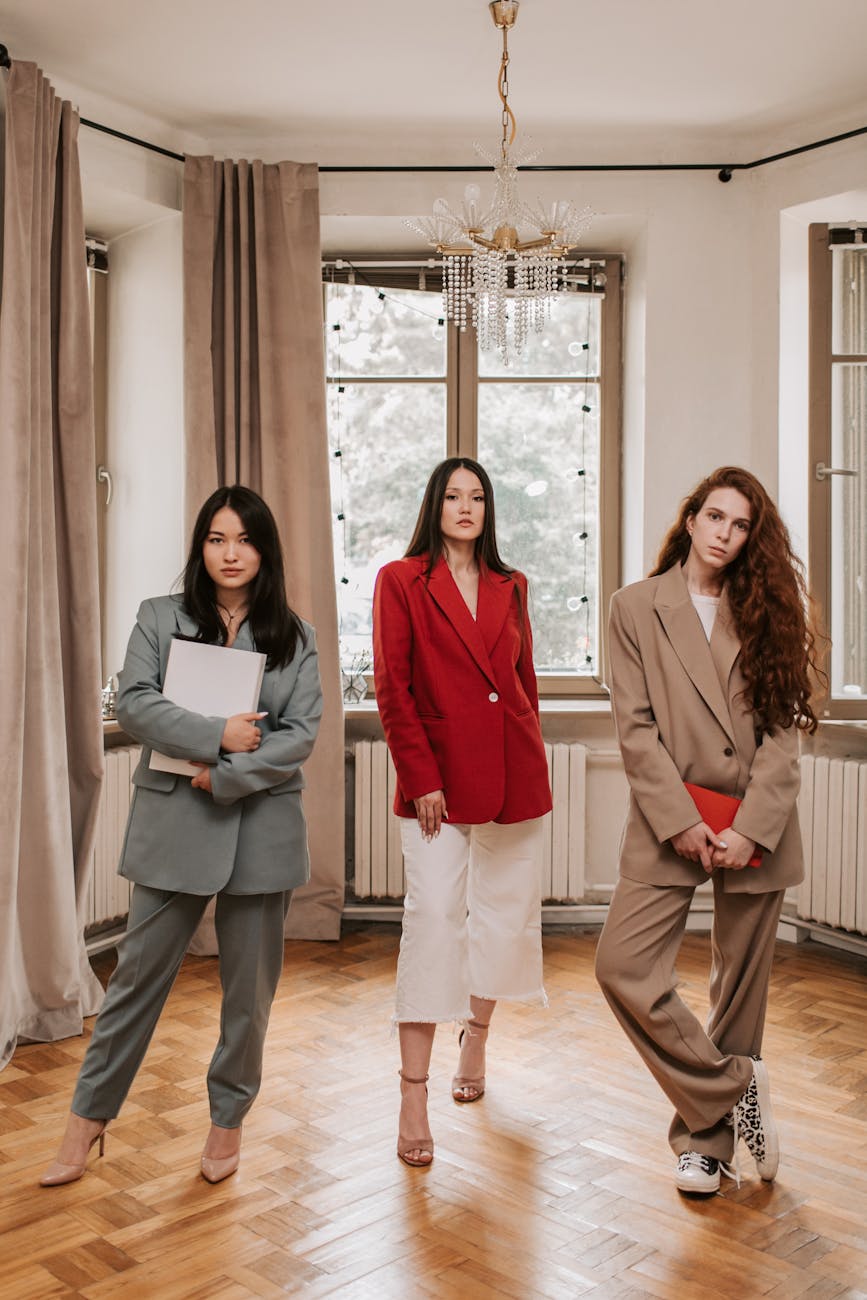 three women in business attires inside an office