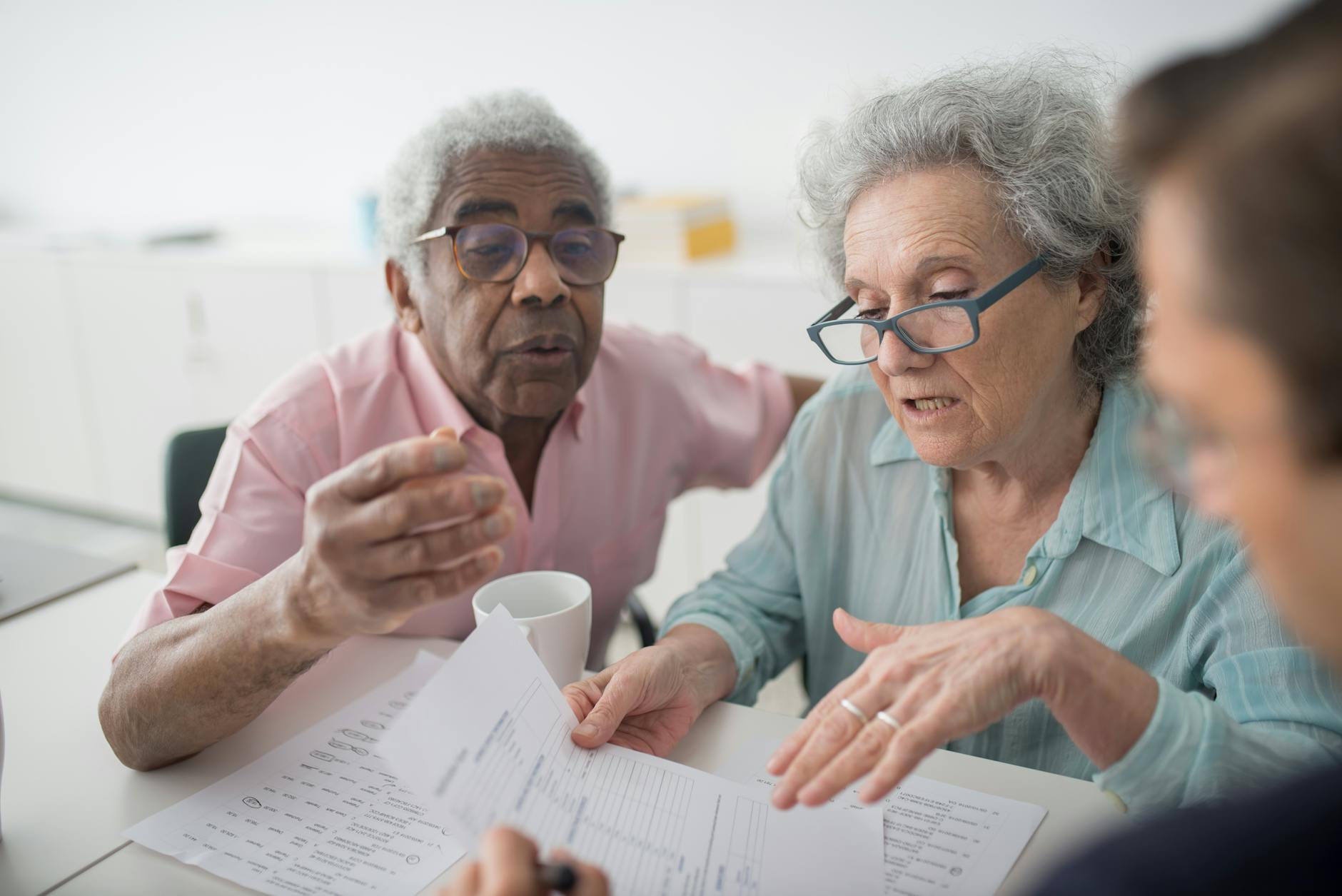 two seniors looking at papers