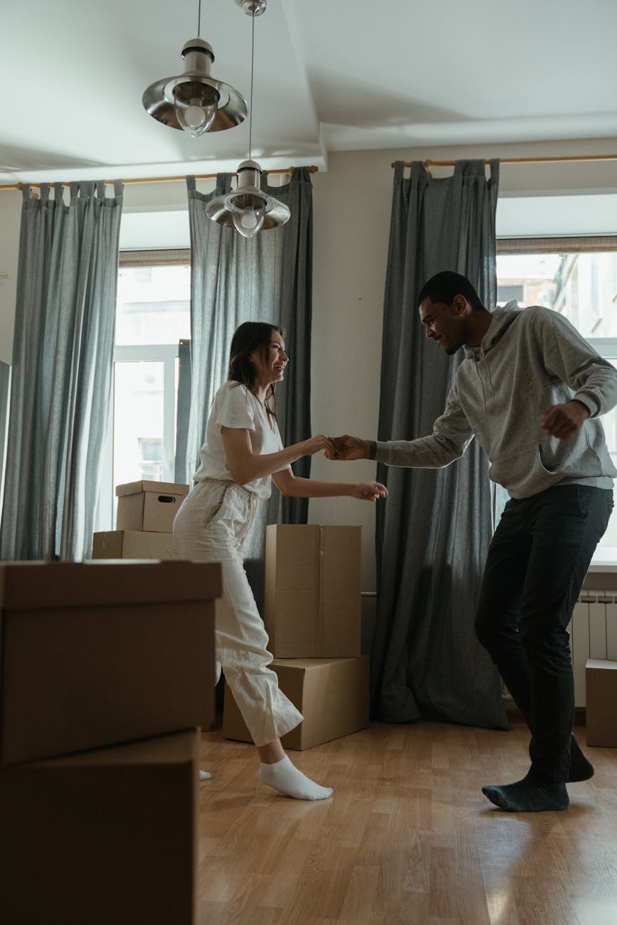 man in white dress shirt and black pants standing beside woman in white long sleeve shirt