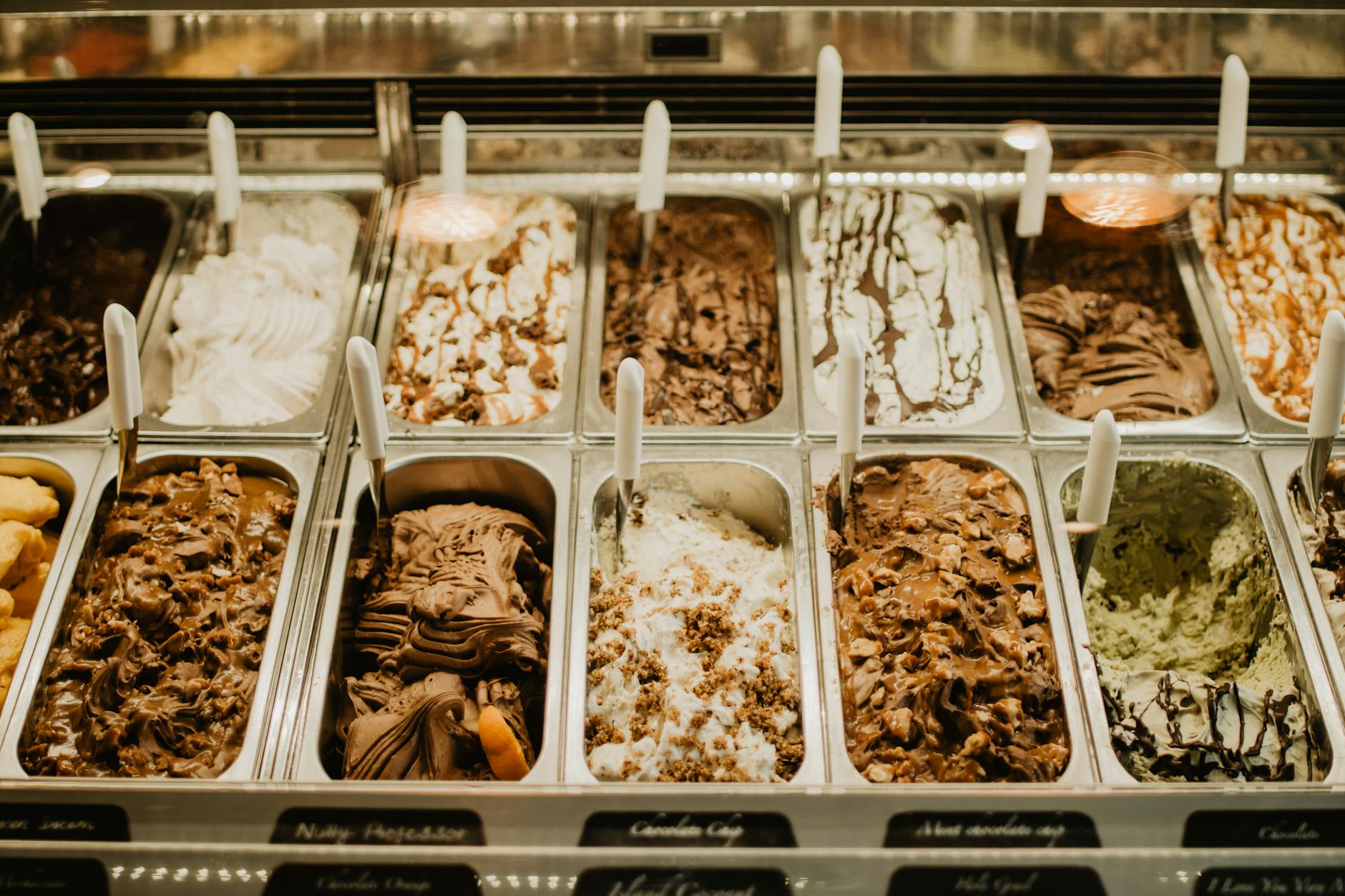 gelato on stainless trays inside a display freezer