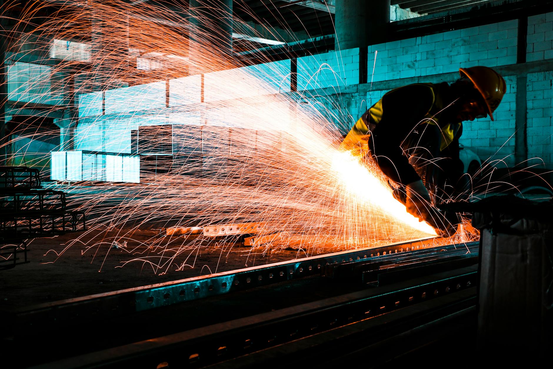 a worker cutting metal