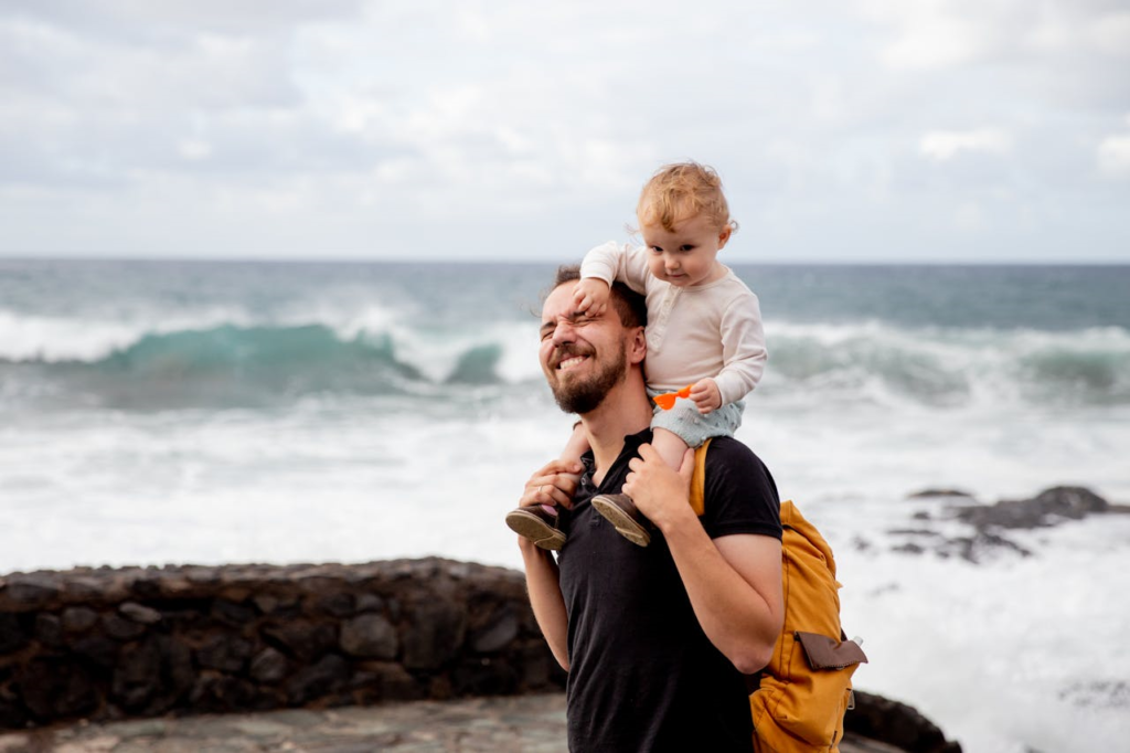 man with child on beach