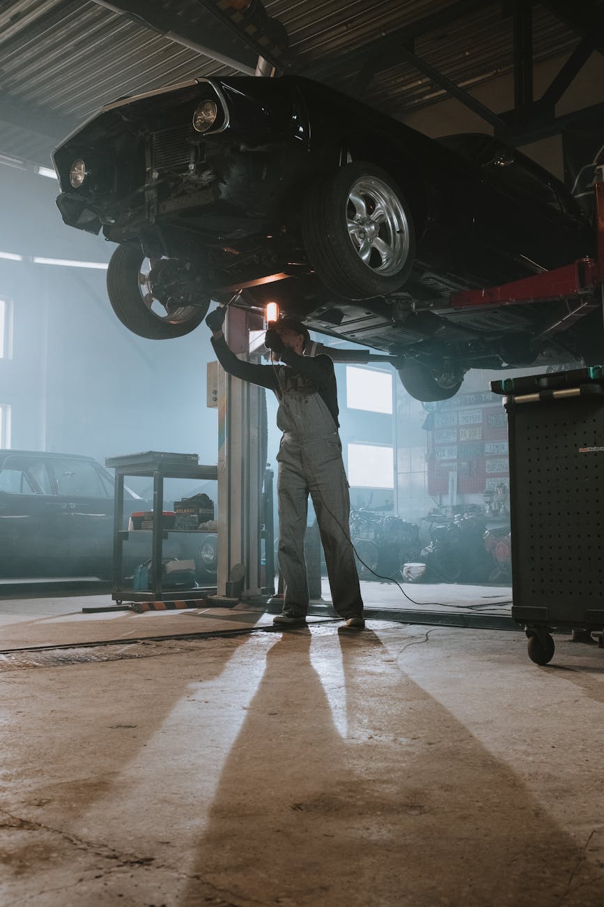 man in black jacket and pants standing beside black car