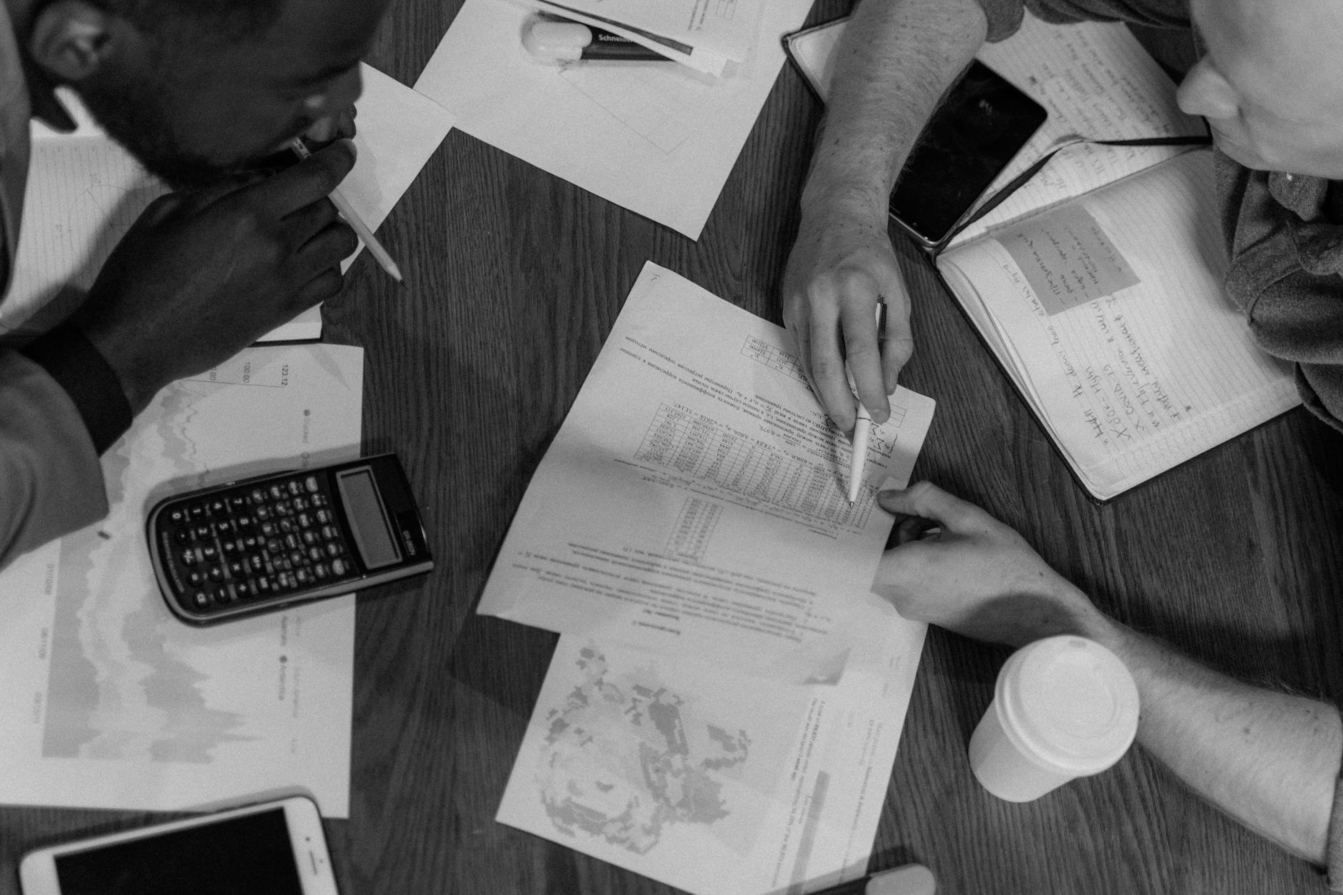 grayscale photo of person holding paper