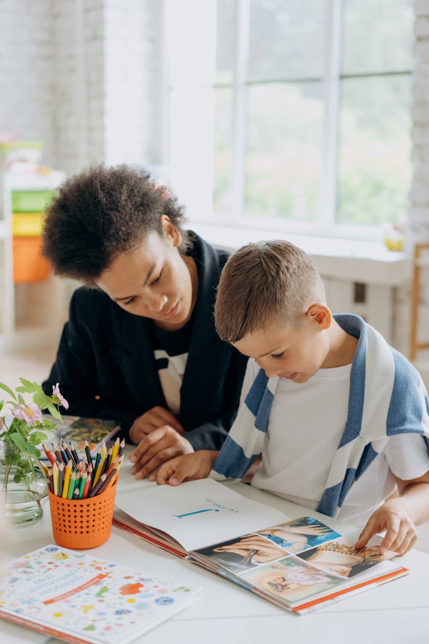 a woman teaching a boy