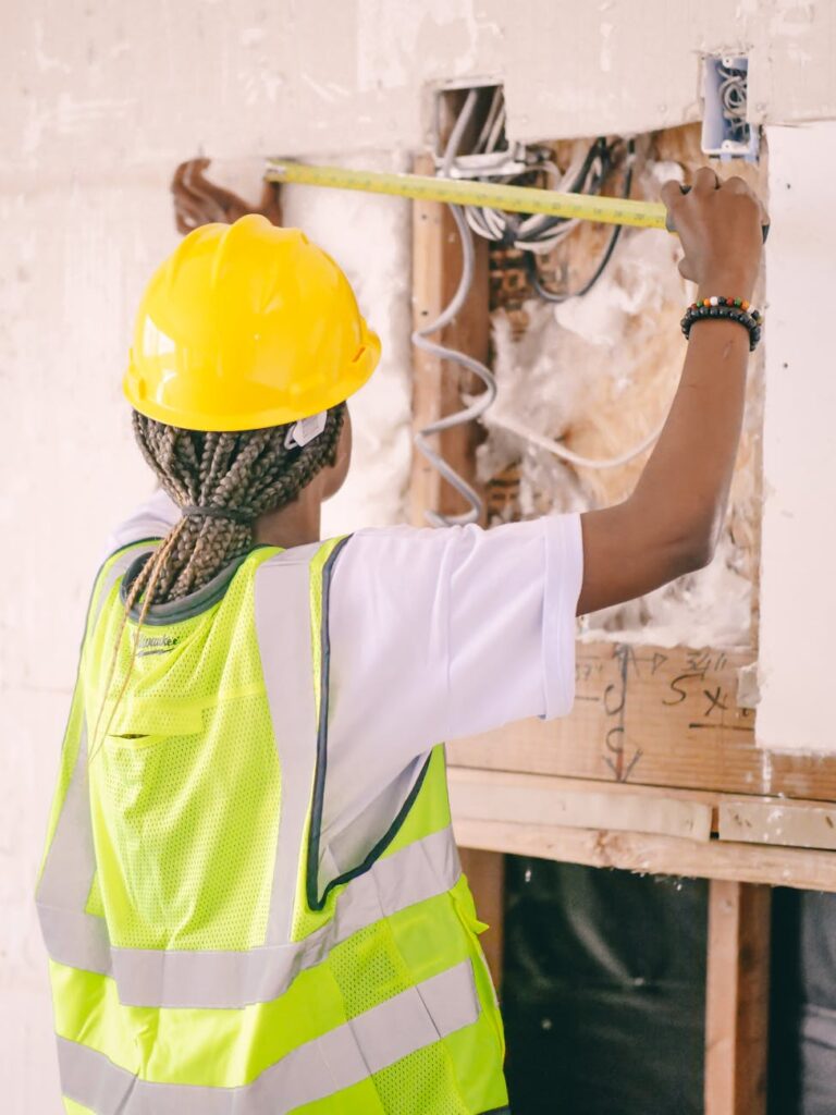 construction worker measuring wall