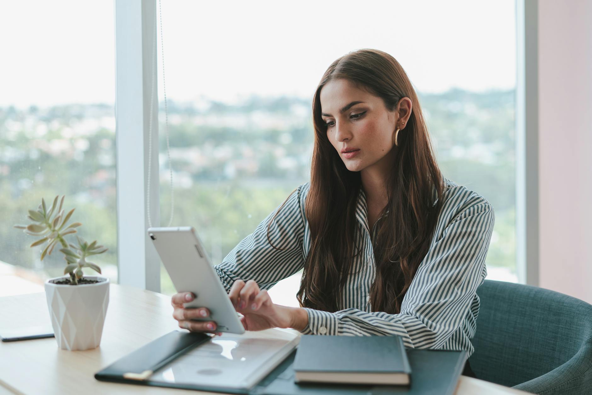 portrait of woman in shirt working on tablet