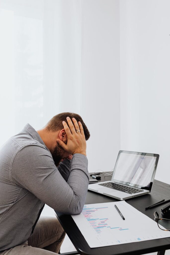 a man in gray long sleeves feeling tired