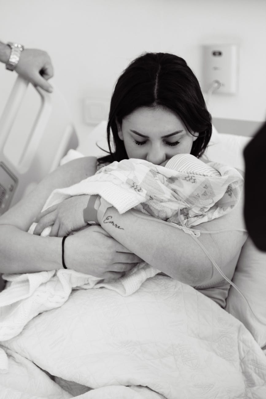 tender moment mother cradling newborn in hospital