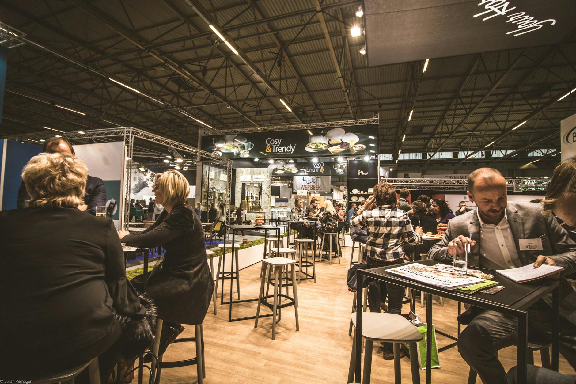 people inside a cafe with tables and chairs