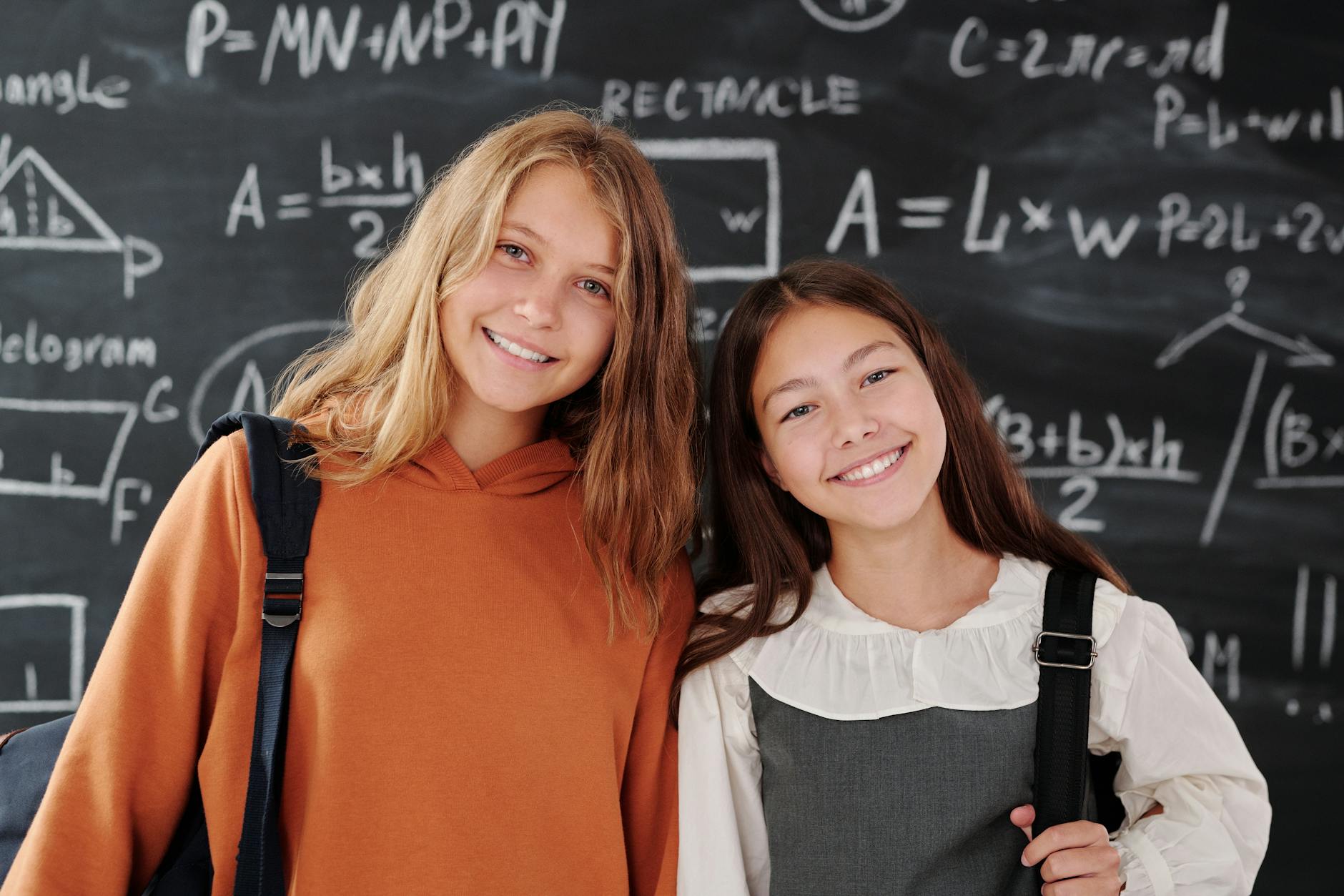 a girls posing behind the blackboard