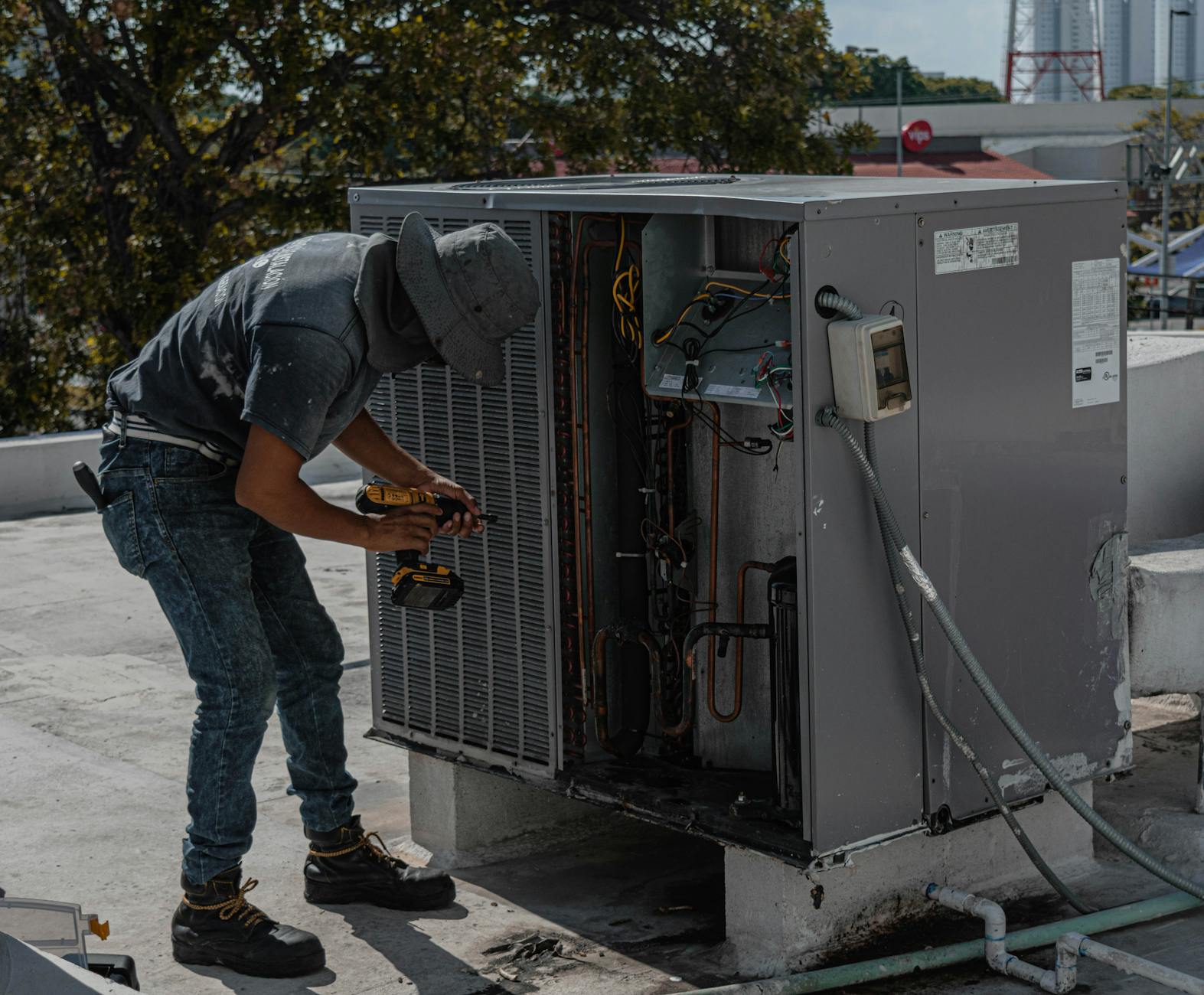 repairman repairing a air conditioner