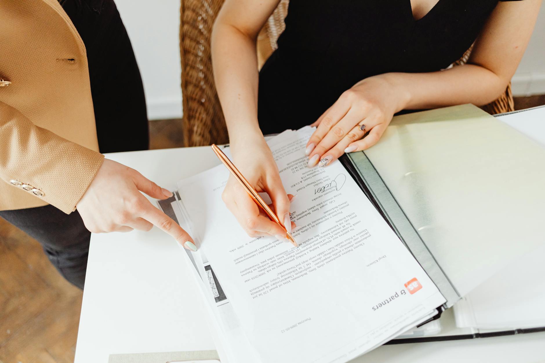 woman in black sleeveless dress writing on paper