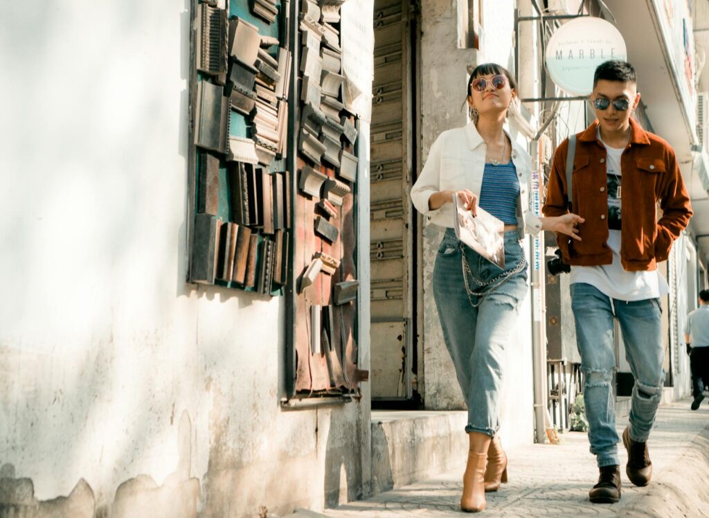 photo of man and woman walking on sidewalk
