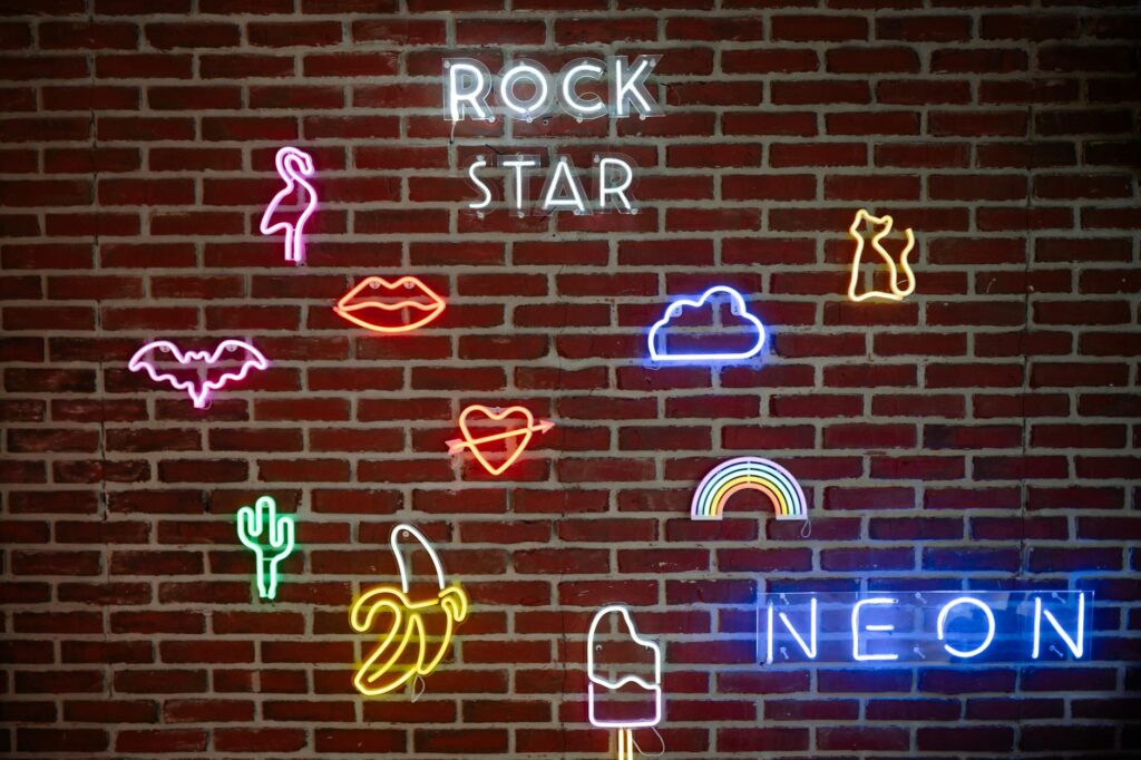 neon signs on a brick wall