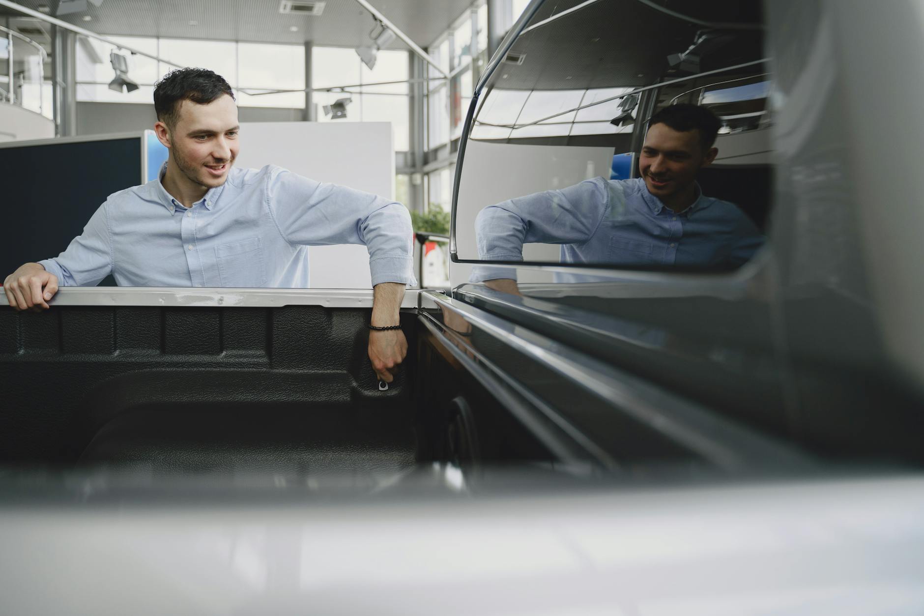 a man looking at a car