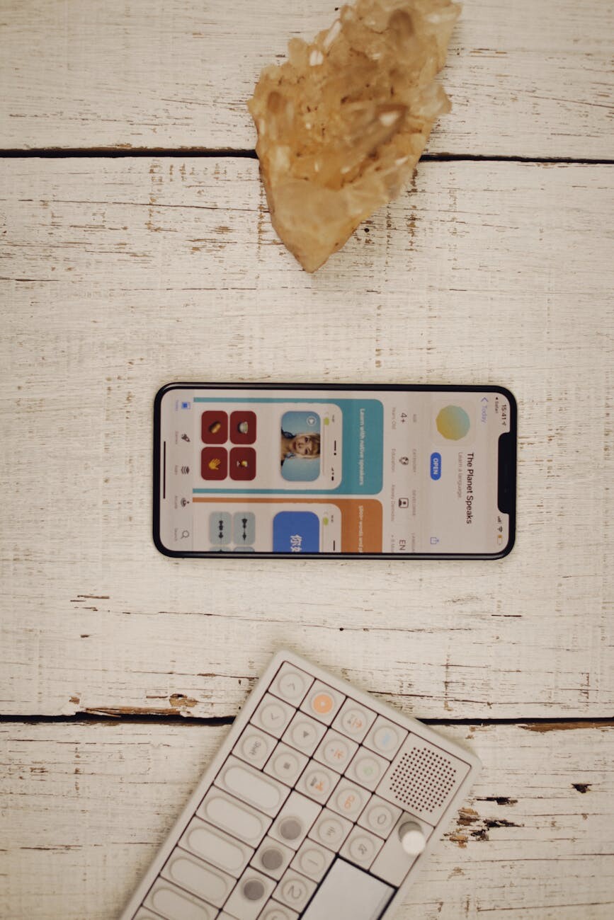 flat lay of smartphone and keyboard on rustic surface