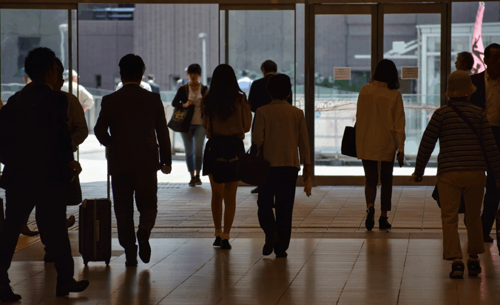 a group of people walking through a lobby