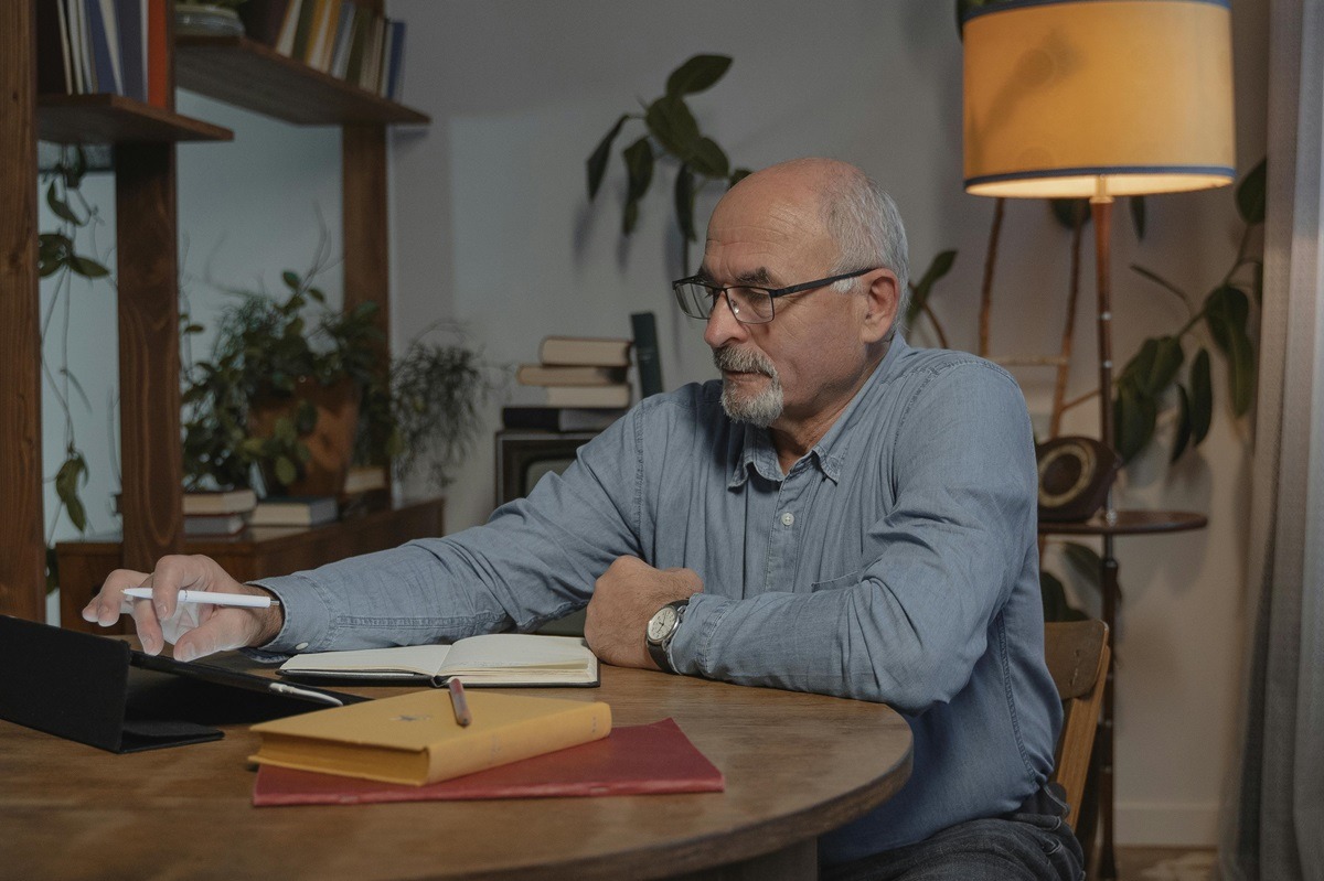 man writing on a notebook