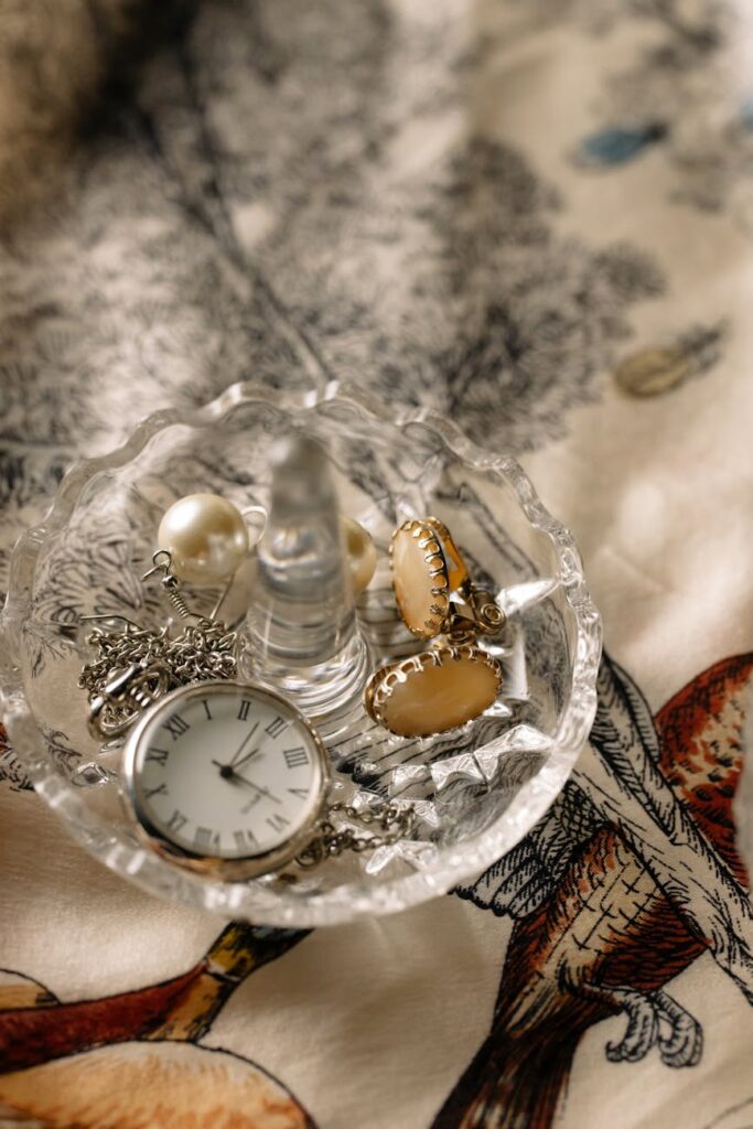 clock and accessories in a clear bowl