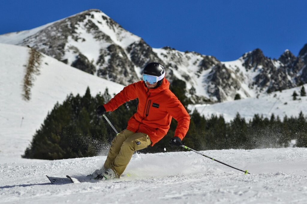 pexels-photo-3600571 - Lead Grow Develop - Business, Technology, Personal Development photo of a man in an orange jacket and beige trousers skiing