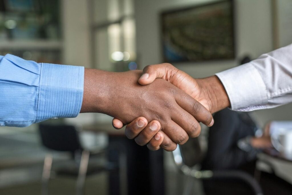 It's important that businesses form connections with people they can trust.  Two people shaking hands


