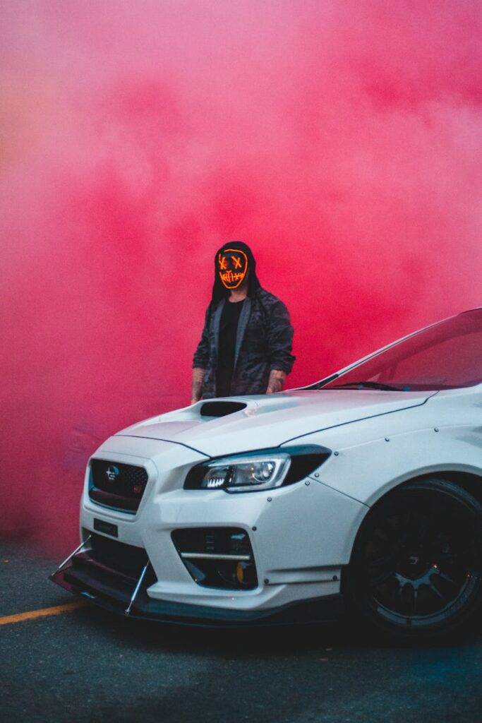 unrecognizable man standing near modern car and bright dusty cloud
