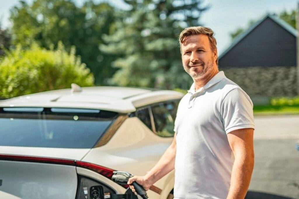 man in front of EV car